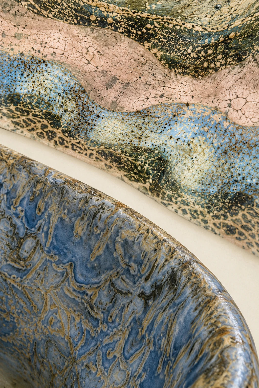 Artistic composition of blue, pink and olive glazed surfaces.